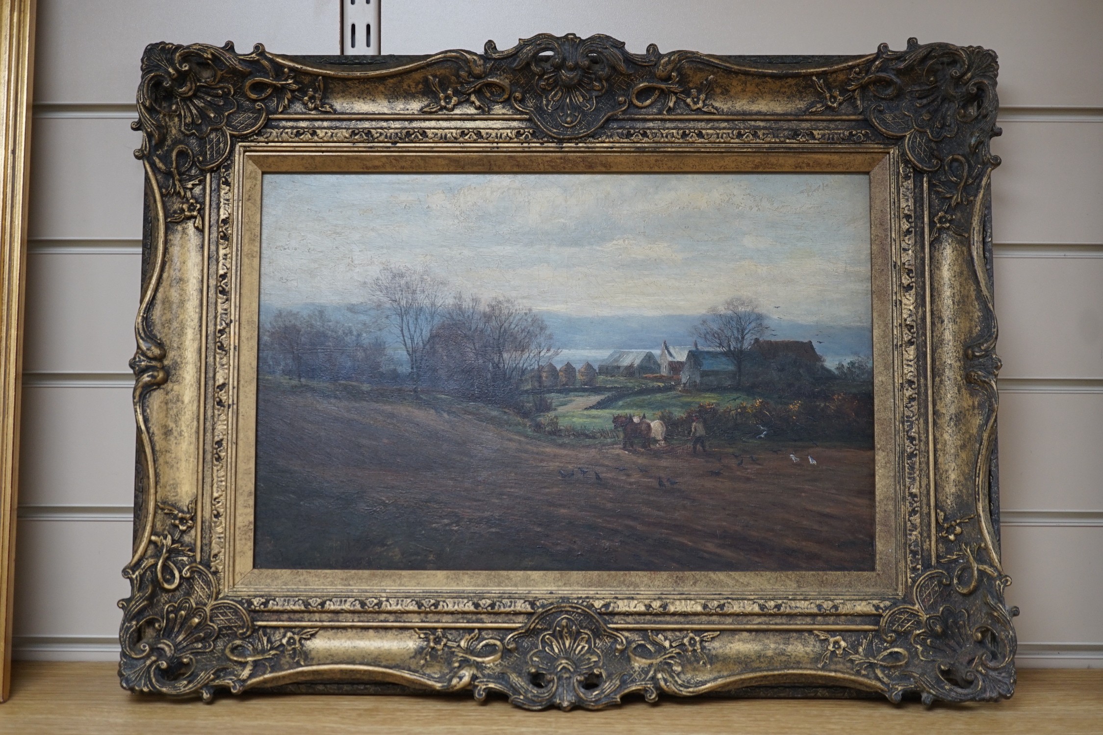 English School, oil on board, Ploughman in a landscape, indistinctly signed, 29 x 44cm